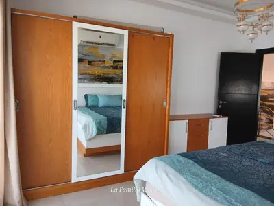 a bedroom with a large wooden cabinet with a bed at Holiday Villa in Hurhgada Egypt in Hurghada