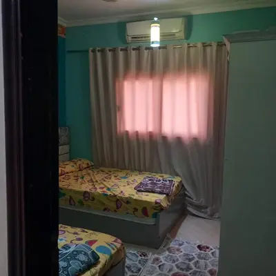 a bedroom with two beds and a window at شقه للايجار اليومي بمدينة الغردقه مميزة جدا in Hurghada