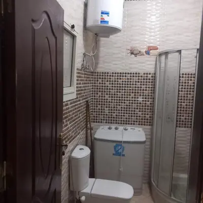 a small bathroom with a toilet and a shower at شقه للايجار اليومي بمدينة الغردقه مميزة جدا in Hurghada