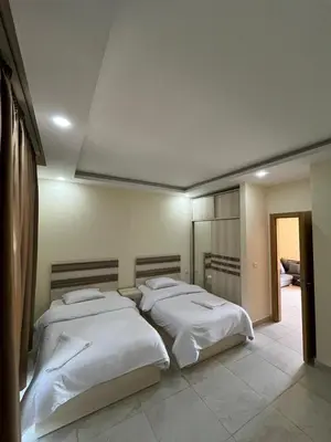 a bedroom with two beds in a room at شاليه في قرية ميراج in Hurghada
