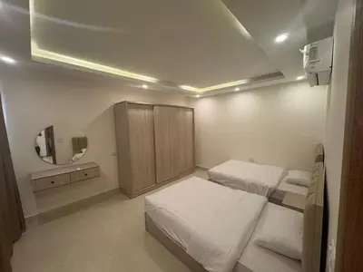 a small bedroom with two beds and a mirror at شاليه في قرية ميراج in Hurghada