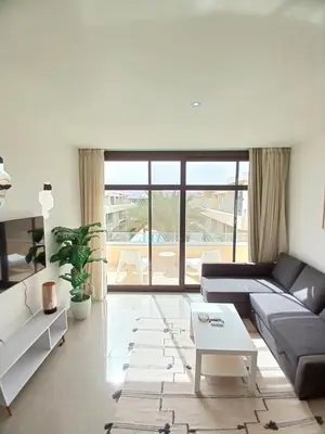 a living room with a couch and a table at Gcribs Onebedroom Elgouna in Hurghada