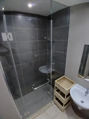 a bathroom with a shower with a sink and a toilet at Gcribs Onebedroom Elgouna in Hurghada