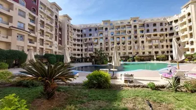 a large apartment building with a large swimming pool at Cozy studio in Florenza Khamsim - I409 in Hurghada