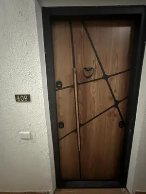 a wooden door in a room with a sign on it at Cozy studio in Florenza Khamsim - I409 in Hurghada