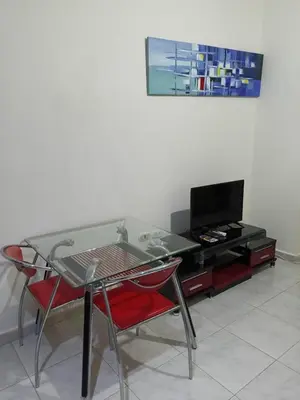 a glass table and chairs in a living room at Studio Lotus Compound Kawser in Hurghada