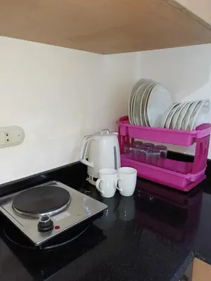 a counter with a tray of plates and cups at Studio Lotus Compound Kawser in Hurghada