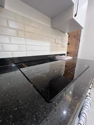 a kitchen with a black counter top in a room at Modern Beachfront Apartment 2 in Hurghada