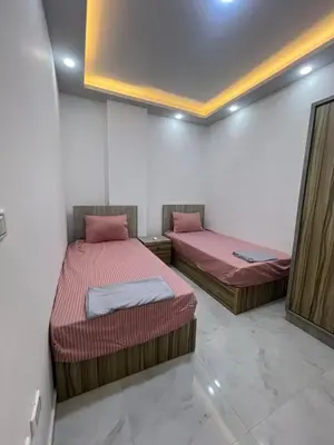two twin beds in a room with at Modern Beachfront Apartment 2 in Hurghada