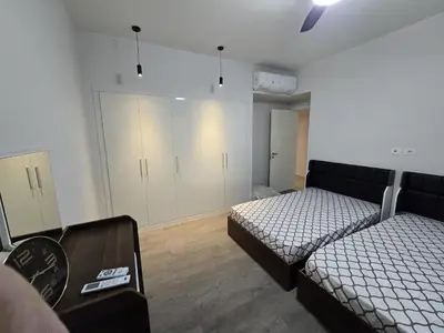 a bedroom with two beds and a closet at Villa at Cyan Ring with infinity pool at lagoon in Hurghada