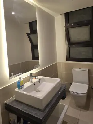 a bathroom with a white sink and a toilet at Villa at Cyan Ring with infinity pool at lagoon in Hurghada