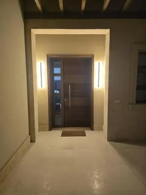 an empty hallway with a door with a mat and lights at Villa at Cyan Ring with infinity pool at lagoon in Hurghada