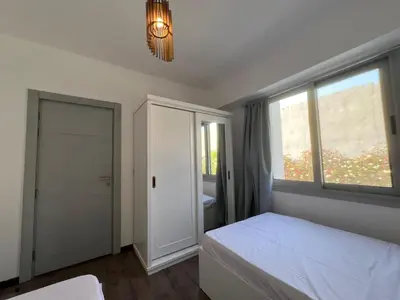a bedroom with a white bed and a window at Bright 2Bdr with Stunning Pool Views – Sholan 1 in Hurghada