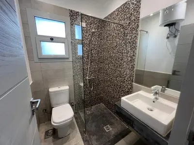 a bathroom with a toilet and a sink at Bright 2Bdr with Stunning Pool Views – Sholan 1 in Hurghada