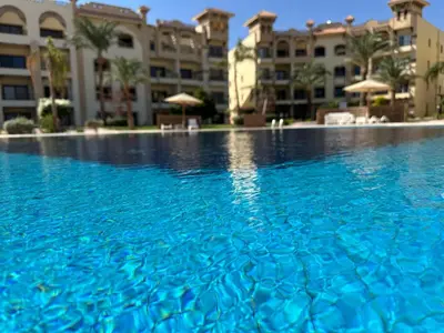 a large swimming pool in front of a building at Al Saraya Sahl Hasheesh by Peaks 1 Bed Apartment with Pool View C116 in Hurghada