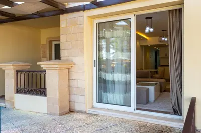 a sliding glass door on a house with a living room at Al Saraya Sahl Hasheesh by Peaks 1 Bed Apartment with Pool View C116 in Hurghada