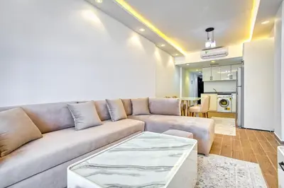 a living room with a couch and a table at Al Saraya Sahl Hasheesh by Peaks 1 Bed Apartment with Pool View C116 in Hurghada
