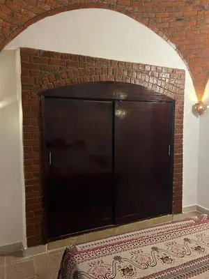 a large black entertainment center in a brick wall at Habu Palace in Luxor