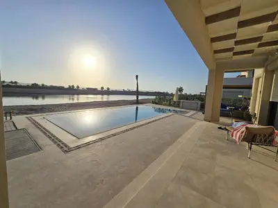 a swimming pool in the middle of a house at El Gouna Cyan Ringe Villa with infinity pool in Hurghada