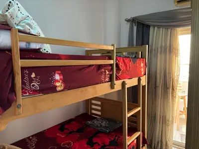 a couple of bunk beds in a room at Apartment in Elhilal, Hurghada in Hurghada