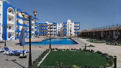 a resort with a swimming pool and some buildings at Oasis Marena in Hurghada
