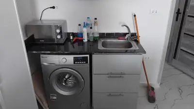 a kitchen with a sink and a washing machine at Oasis Marena in Hurghada