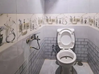 a bathroom with a white toilet in a room at Nubian Home by Sara in Nag` el-Ramla