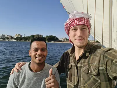 two men on a boat giving the thumbs up at Mary sailboat adventure in Luxor