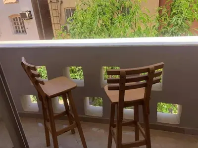 two chairs sitting on a balcony with a window at Waleed in Hurghada