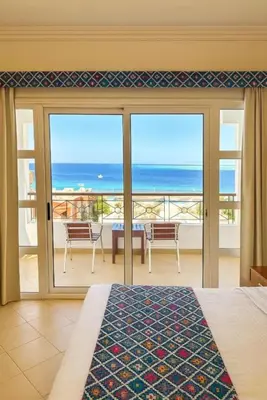 a bedroom with a view of the ocean at Swiss Wellness Down Town Hotel in Hurghada