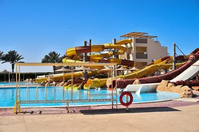 a pool with a water slide in a resort at Al karma aqua beach in Hurghada