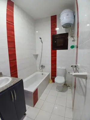 a bathroom with a tub and a toilet and a sink at الشيراتون شارع السنترال السياحي in Hurghada