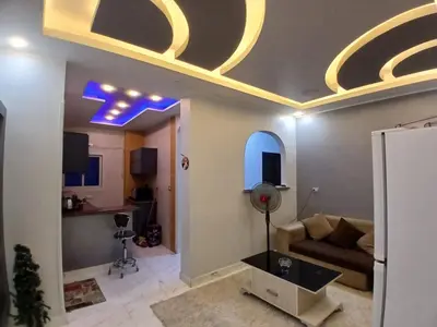 a living room with a ceiling with blue lights at الشيراتون شارع السنترال السياحي in Hurghada
