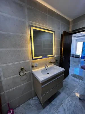 a bathroom with a sink and a mirror at Niebieski Apartament in Hurghada