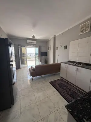 a large living room with a couch and a kitchen at Nile Spirit View in Luxor
