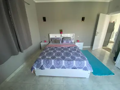 a bedroom with a bed with a blue and white comforter at Nile Spirit View in Luxor