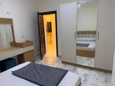 a room with a bed and a mirror and a bedroom at Two Bedroom Apartment in Hurghada