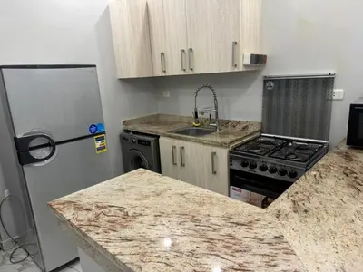 a kitchen with a refrigerator and a counter top at Two Bedroom Apartment in Hurghada
