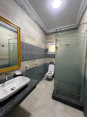 a bathroom with a shower and a sink and a toilet at Poraa roof in Hurghada