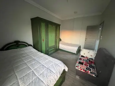 a bedroom with a bed and a dresser in it at Poraa roof in Hurghada