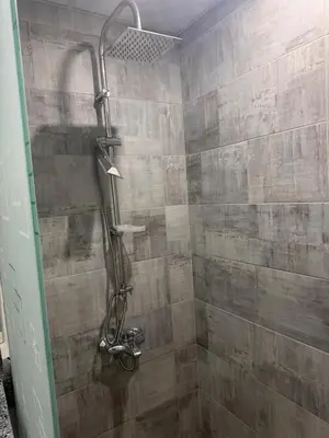 a shower in a bathroom with a stone wall at Scandic Resort A531 in Hurghada