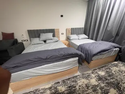 a bedroom with two beds and a couch at Scandic Resort A531 in Hurghada