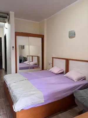 a bedroom with two beds and a large mirror at nice apartment in Hurghada