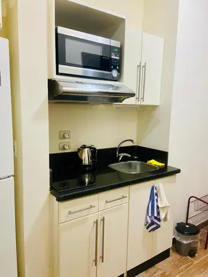 a small kitchen with a sink and a microwave at nice apartment in Hurghada