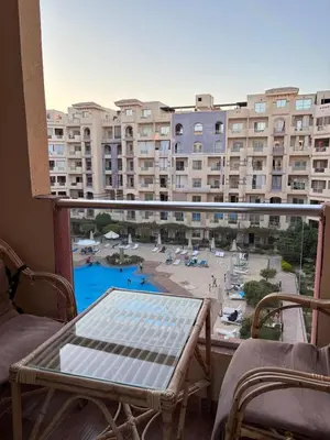 a balcony with a view of a pool and buildings at nice apartment in Hurghada