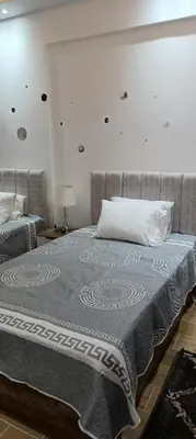 a bedroom with a bed with a blue blanket on it at Bay View, Sahl Hashish, Hurghada in Hurghada