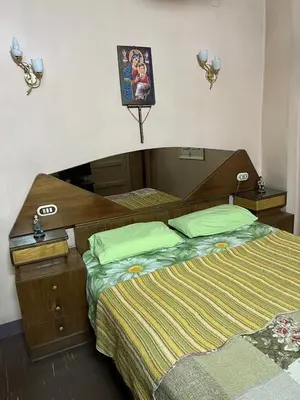 a bedroom with two beds and a picture on the wall at Velvet Rose Apartment in Luxor