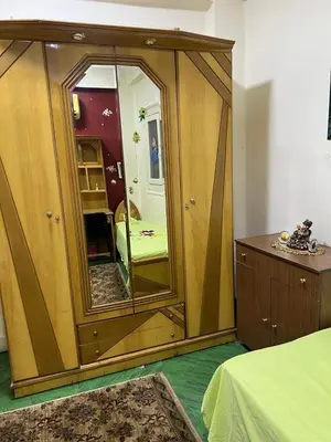 a bedroom with a large mirror in a room at Velvet Rose Apartment in Luxor