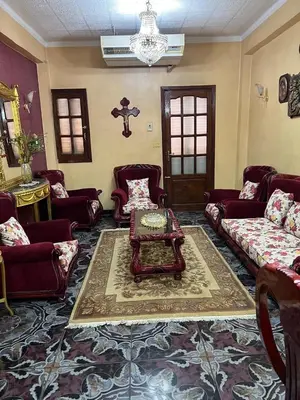 a living room with couches and a coffee table at Velvet Rose Apartment in Luxor