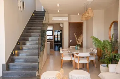 a staircase in a home with a table and chairs at Chic Cyan 4BR Villa with Private Pool in Hurghada